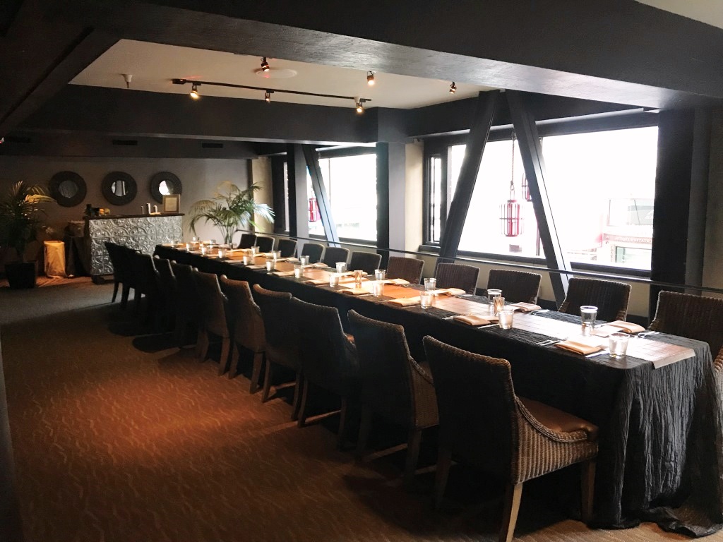 E&O restaurant in San Francisco, a large private dining room showing a long table with several chairs on either side