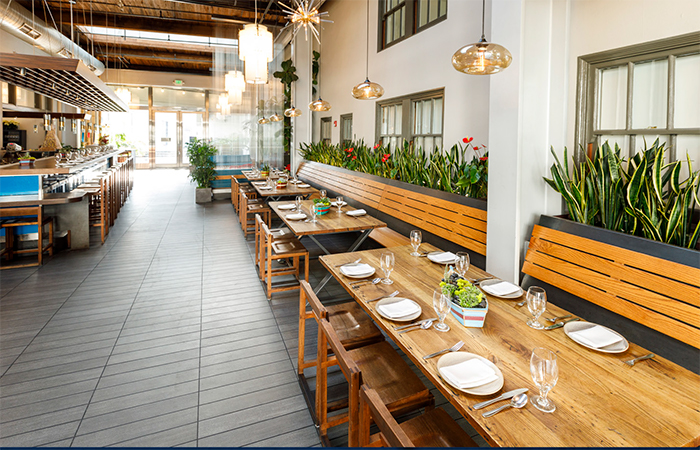 Cebiche Lounge in La Mar Cebicheria Peruana in San Francisco, showing long tables against the wall with bench and chair seating