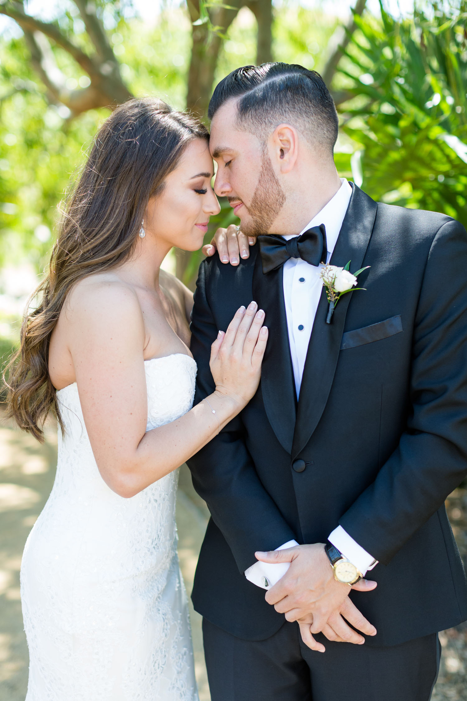 bride and groom touching foreheads with eyes closed