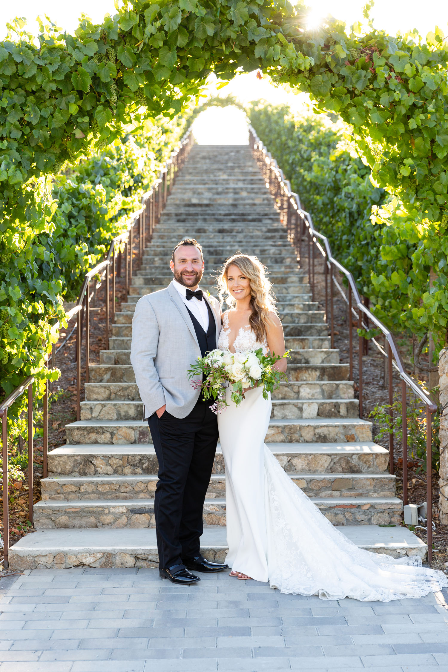 Whitney and Ty at base of steps at Nella Terra Cellars